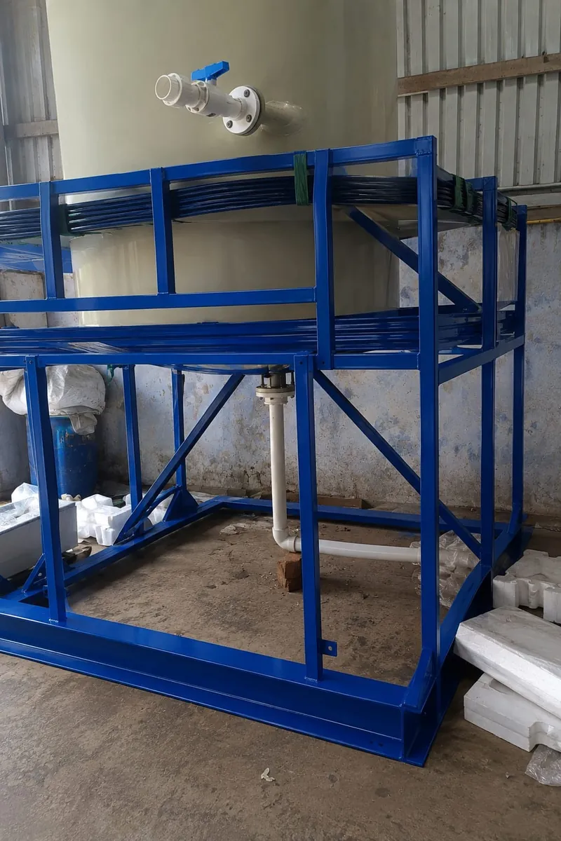 Fabricated steel skid supporting an agitated chemical tank with bottom entry drive